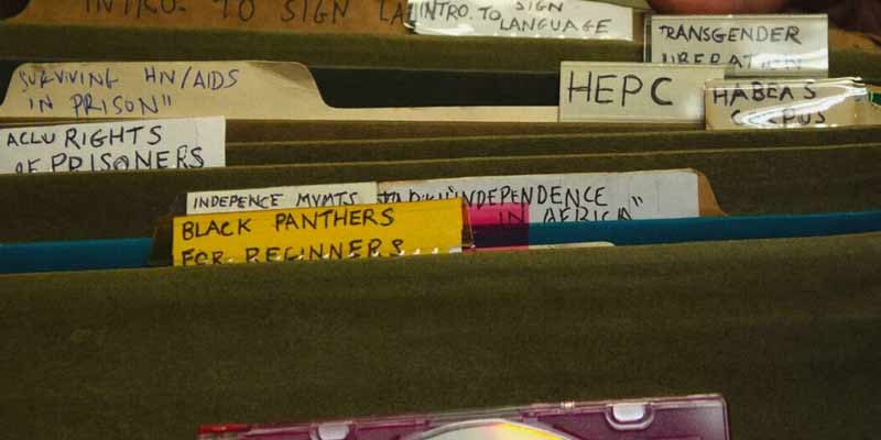 Filing cabinet with folders for black panthers for beginners, ACLU rights of prisoners, HEPC, Habeas Corpus, Transgender liberation, surviving HIV/AIDS in prison, and intro to sign language