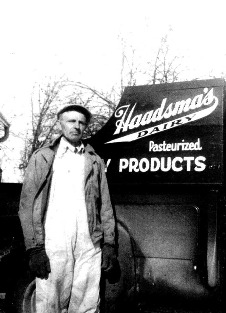 Man standing in front of dairy truck